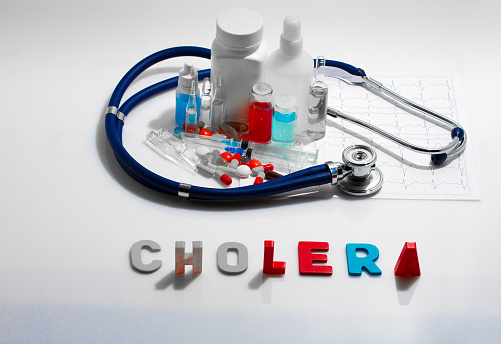 Diagnosis - Cholera. Medical concept with pills, injection, stethoscope, cardiogram and a syringe