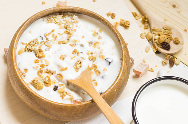 istock Muesli with milk in a rustic wooden bowl 489641168