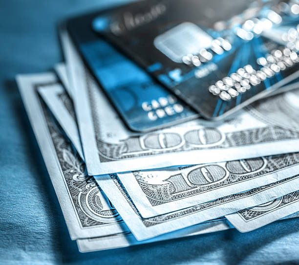 istock Credit cards and dollars in cash 489643134