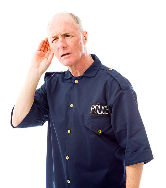 Policeman trying to listen Policeman trying to listen old man cupping his ear to hear something stock pictures, royalty-free photos & images