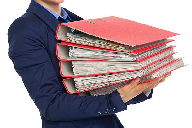 istock closeup on business woman with stack of folders 489644523
