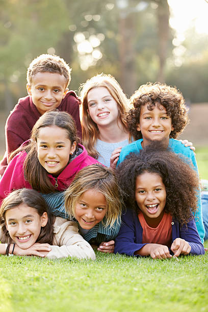 istock Group Of Children Lying On Grass Together In Park 489646329
