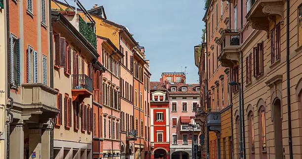 Colourful architecture and buildings along the streets of Bologna in the Ialian region of Emilia Romanga