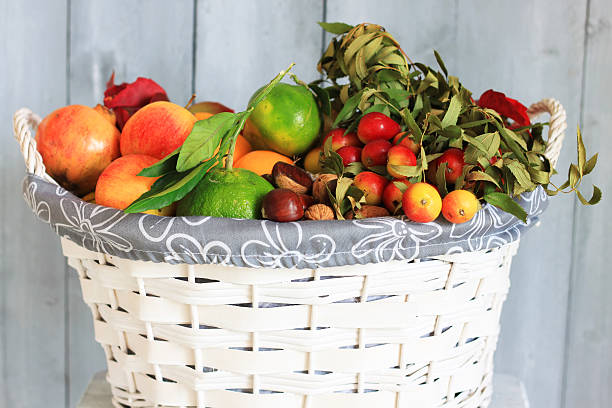 Photo of white basket with autumn fruits