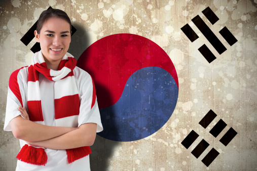 Football fan in white wearing scarf against south korea flag