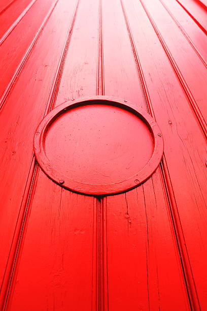 istock Red painted wooden gate with circle 489649947