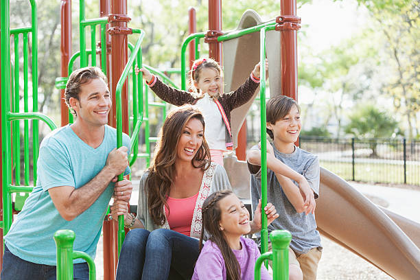 istock Mixed race family at park 489649973