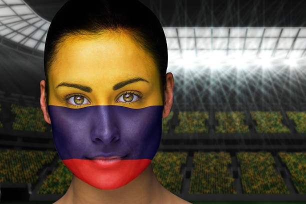 Beautiful colombia fan in face paint Composite image of beautiful colombia fan in face paint against vast football stadium with fans in yellow football2014 stock pictures, royalty-free photos & images
