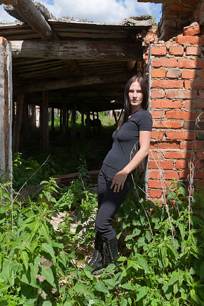 istock girl in black among ruins 489650345