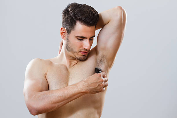 Man shaving his armpit stock photo
