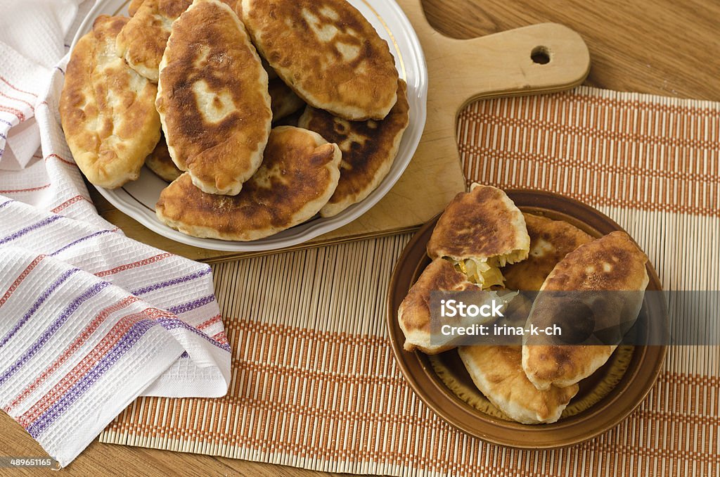 Fried fresh tasty pasties Fried fresh delicious pastry stuffed with cabbage Appetizer Stock Photo