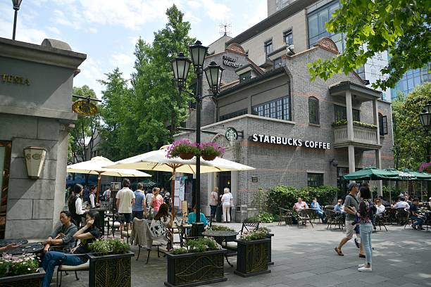 Shanghai, China - May 13, 2015: People walking and sightseeing in Xintiandi, a landmark entertainment area in the heart of downtown Shanghai, with many restaurants, bars, and boutiques. 