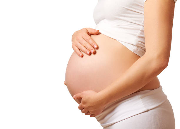 belly tummy of  pregnant woman on white background - pregnant isolated on white stockfoto's en -beelden