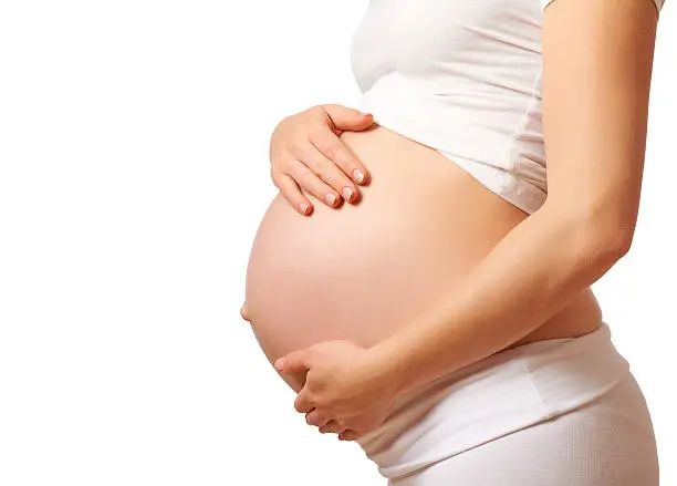 Photo of belly tummy of  pregnant woman on white background