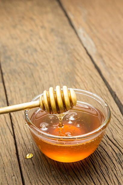 istock Honey in bowl on wood background 489661684