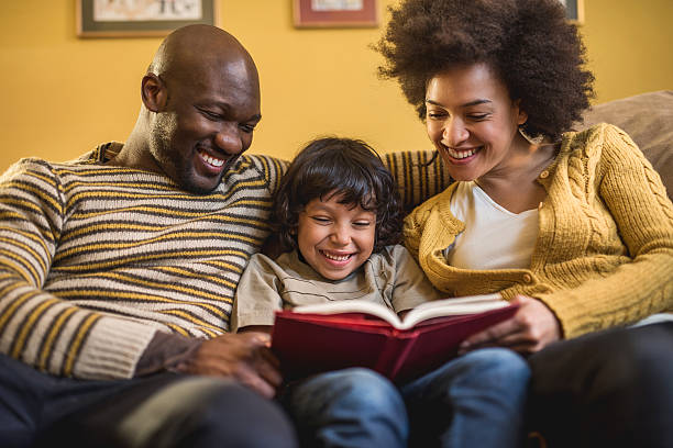 istock African American family relaxing while reading a book at home. 489661736