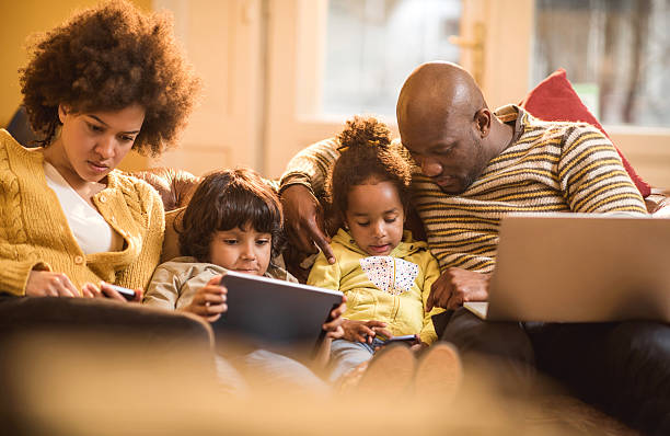 istock African American family using wireless technology at home. 489661938