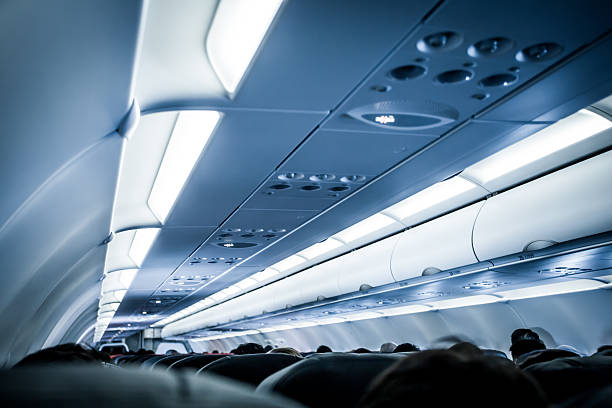 Blurred image of airplane interior in blue color filter Blurred image of airplane interior in blue color filter passenger cabin stock pictures, royalty-free photos & images