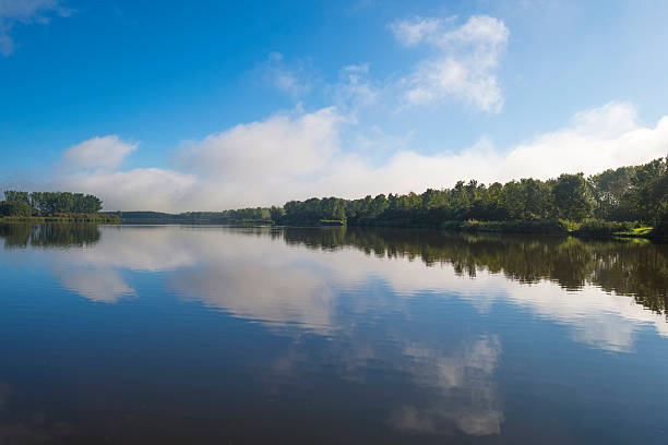 istock The shore of a lake below a blue cloudy sky 489663572