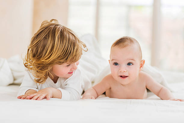 istock Smiling little brothers lying down in bed. 489665656