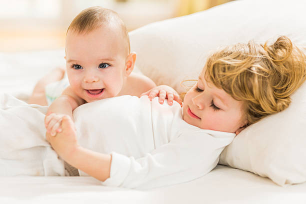 istock Cute little brothers relaxing in bedroom. 489666426