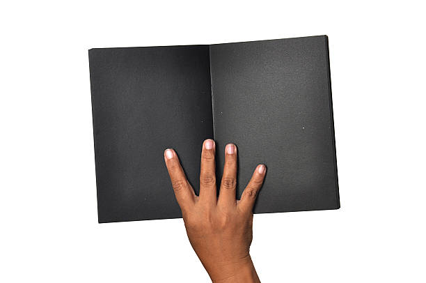 istock femalewoman hand hold a emptyblank black bookdiary 489666428