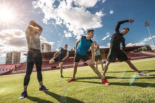 istock Group of athletic men warming up before exercising on stadium. 489666882