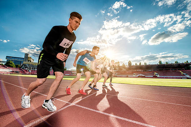 istock Group of young athletic men on a starting line. 489667224