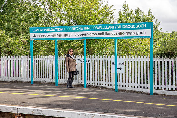 istock Mature woman standing on railway station platform at Llanfairpwllgwyngychgogerychwyrndrobwllllantysiliogogogoch 489668642