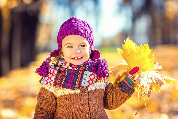 istock Little girl playing with autumn leaves 489670184