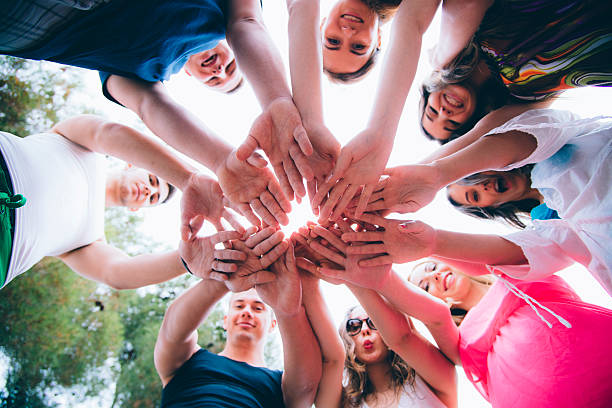 istock Group of People Standing in a Circle with Hands Together 489672806