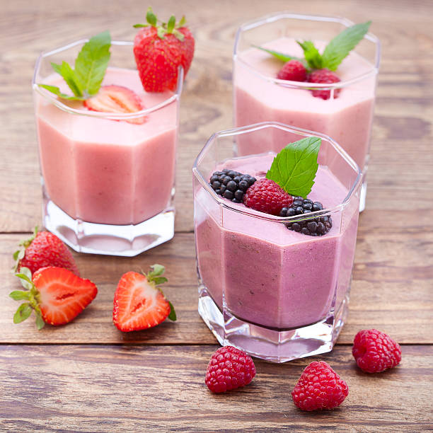 istock Drink smoothies summer strawberry, blackberry, kiwi, raspberry on wooden table. 489673342
