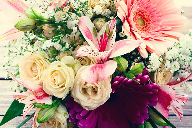 istock Flowers rose on wooden surface. 489673660