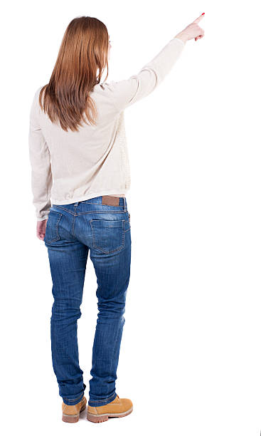 istock Back view of  pointing woman. 489673828