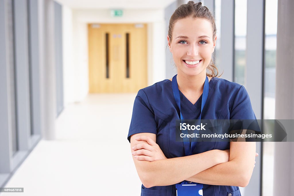 Portrait Of Female Nurse Standing In Hospital Corridor Nurse Stock Photo