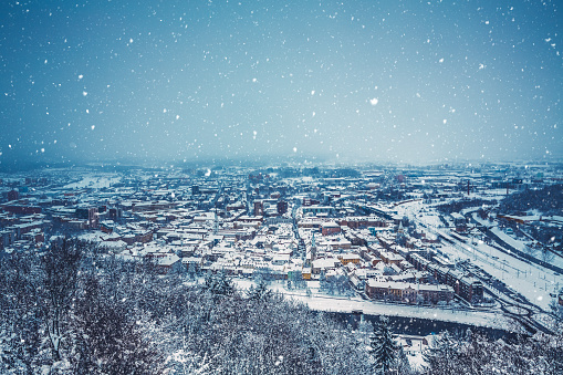 View on town Celje in Slovenia on a snowy winter evening.