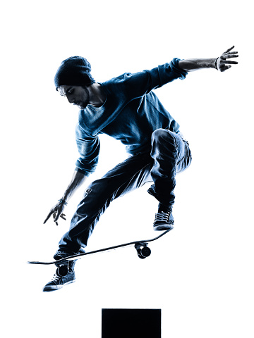 one caucasian man skateboarder skateboarding  in silhouette isolated on white background