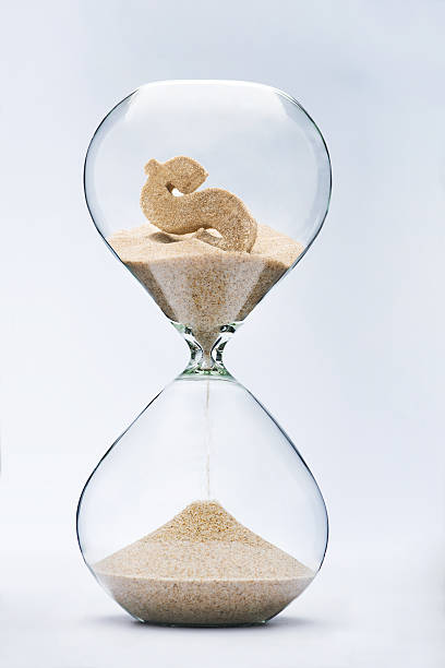Time is money Time is money. Dollar sign flowing down in the hourglass. 2015 stock pictures, royalty-free photos & images