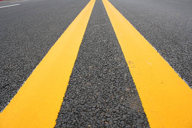 istock Double Yellow Line On Asphalt Road 489692897