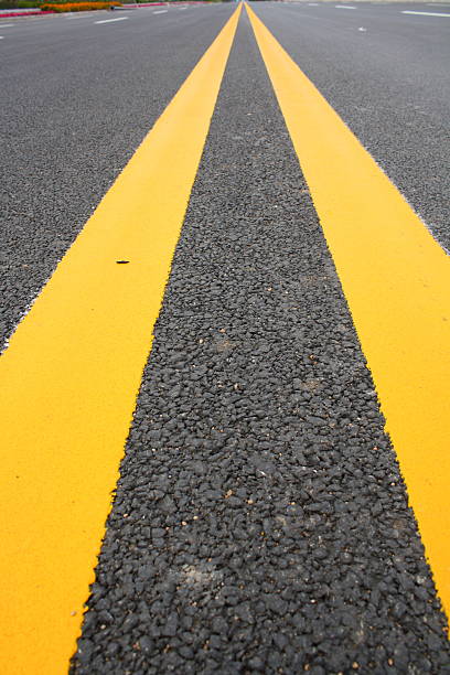 istock Double Yellow Line On Asphalt Road 489692899