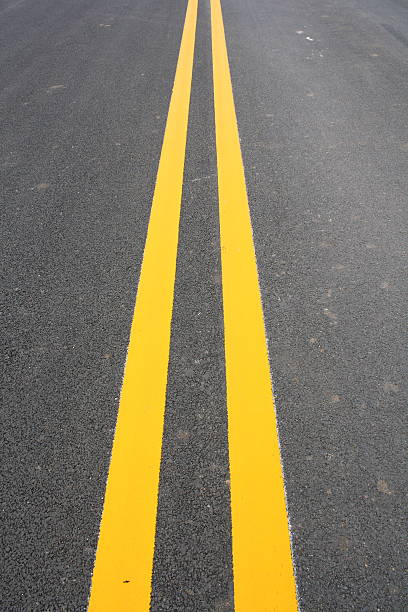 istock Double Yellow Line On Asphalt Road 489692903