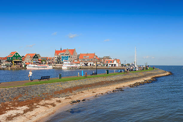 Volendam, Netherlands - October 24, 2013; people on the pier at the harbor of the Dutch village of Volendam