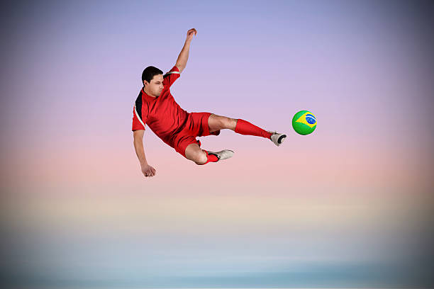 istock Fit football player jumping and kicking 489693641