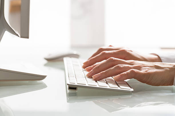 istock Close-up of hands woman using a mouse and keyboard computer 489693673