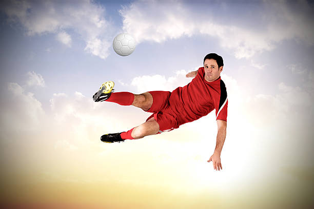 istock Football player in red kicking 489693689