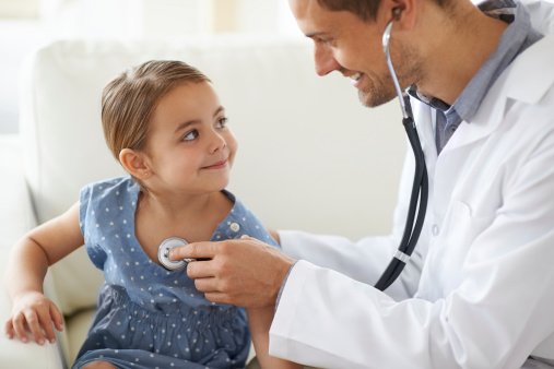 Shot of a handsome male doctor with an adorable young girl for a patient