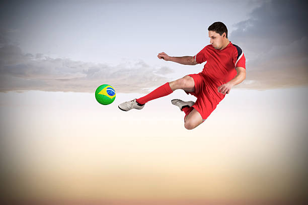 istock Fit football player jumping and kicking 489693867