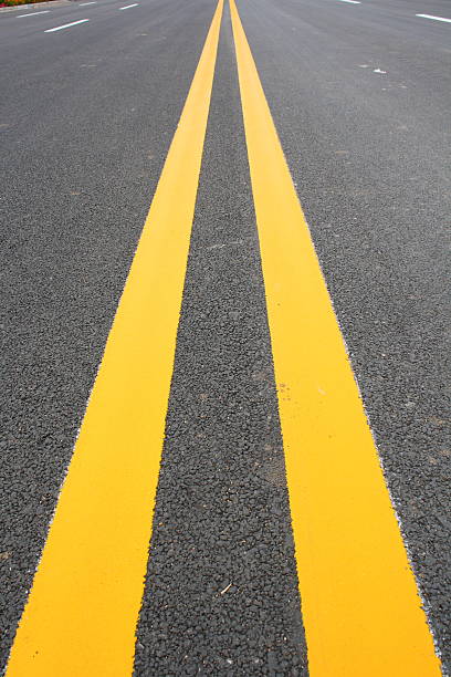 istock Double Yellow Line On Asphalt Road 489693943