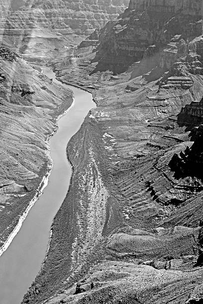 This is a view down the Grand Canyon with the Colorado River and the rocks reflecting the afternoon sun. It is in black and white to enhance the stark feel of the landscape.