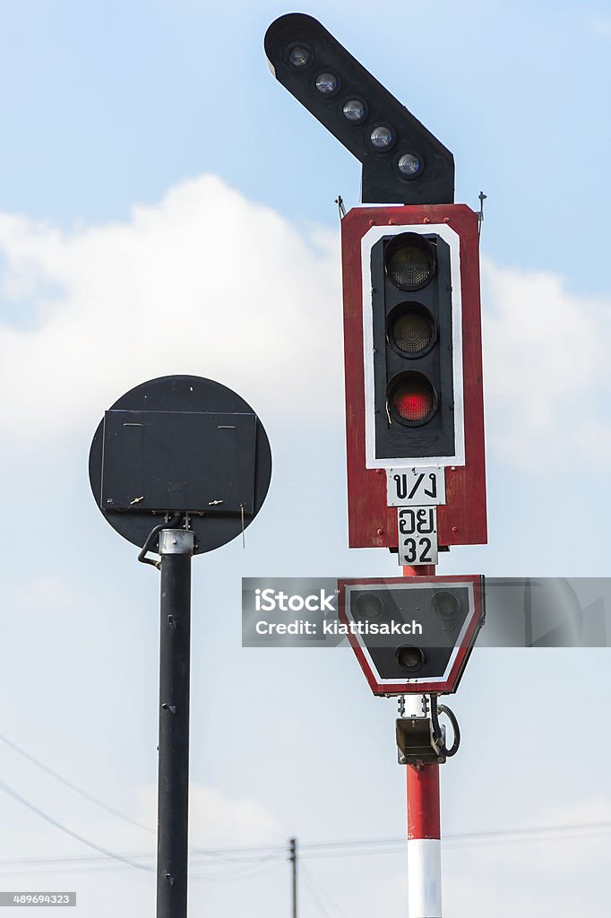 Railway crossing Traffic light at the railroad track Back Lit Stock Photo